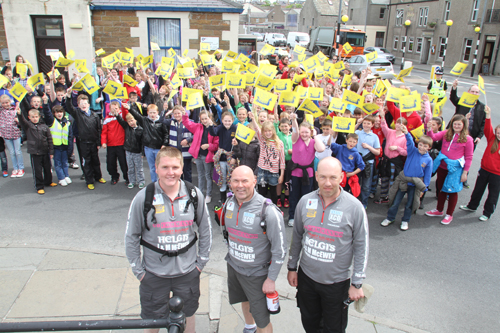Herbie Bremner, Richard Walker and Chris Sharpe head off on their walk with support from Papdale pupils. (Picture: The Orcadian)