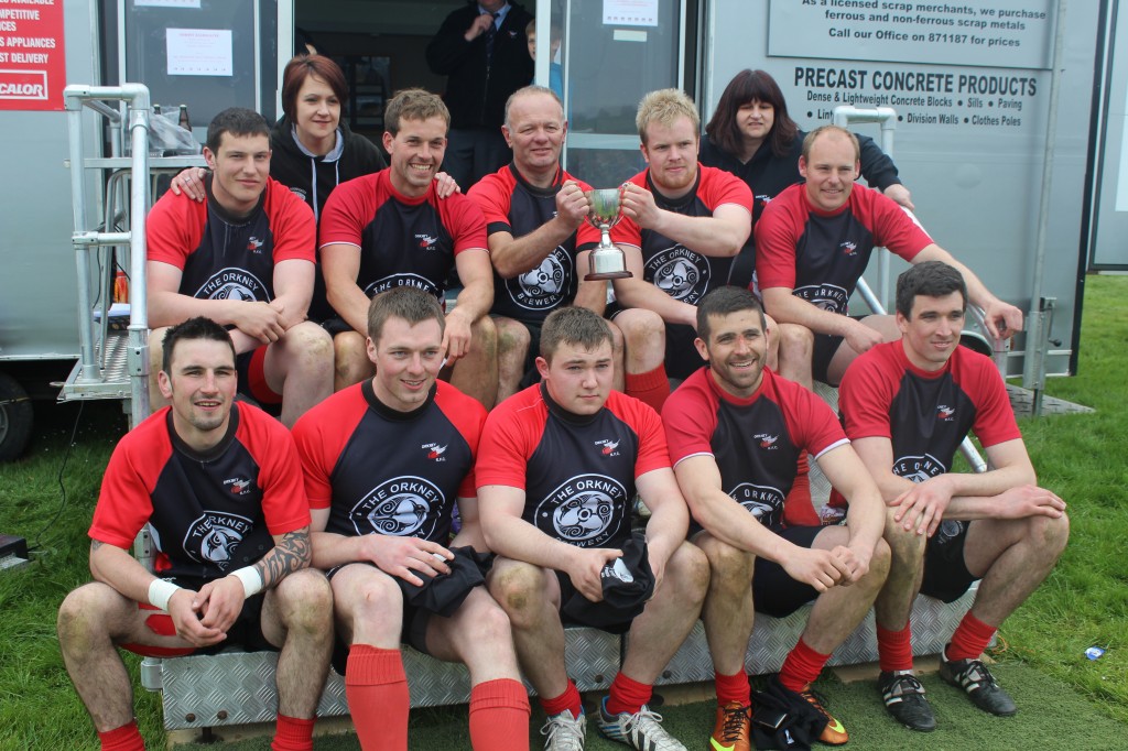 The victorious Orkney rugby team celebrate their third sevens win in a row