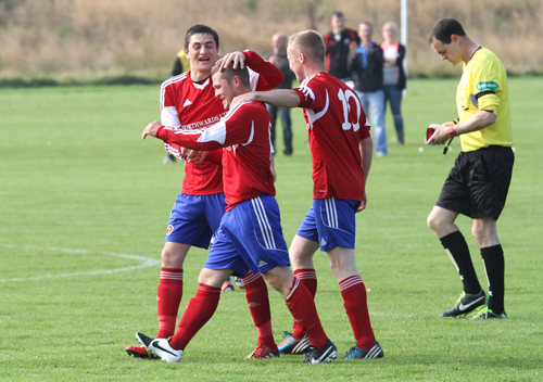 Hat trick scorer Chris Hellewell, is congratulated by teammates John Pickles (left) and Graham Shearer, after scoring Orkney's second goal.