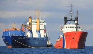 The cargo ship, Industrial Kennedy pictured arriving in Lerwick on Saturday alongside the Coastguard tug. (Picture: Ian Leask) 