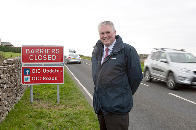 OIC head of roads Darren Richardson with one of the new signs.