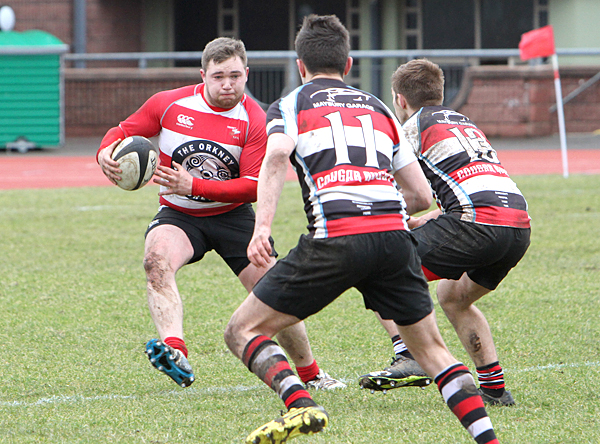 Scott Rendall evades challenges from Orkney's recent 20-18 win over RHC in Kirkwall.