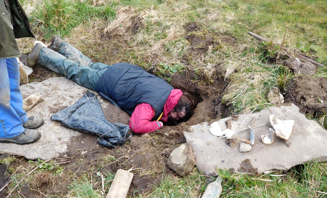 County archaeologist Julie Gibson at the entrance to the underground chamber. (Archaeology Institute UHI)