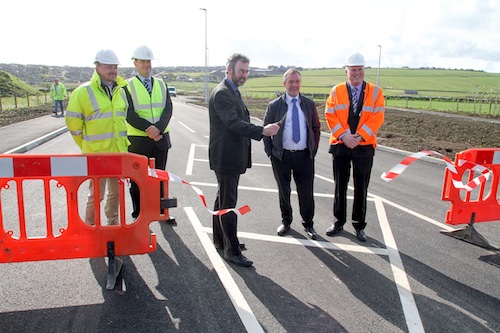 OIC convener Councillor Steven Heddle opens Foreland Road this morning. He is pictured with, from the left, OIC engineer Neil Gauld, Bruce Sinclair representing the contractors, Councillor James Stockan, and OIC head of roads Darren Richardson. (www.theorcadianphotos.co.uk)