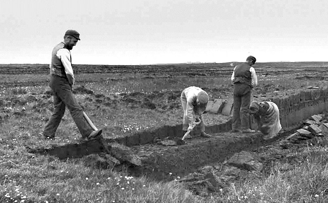 A Tom Kent photograph of peat cutters at work.